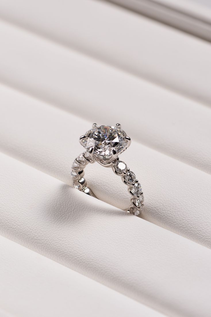 Diamond solitaire ring on textured fabric, jewellery product photography