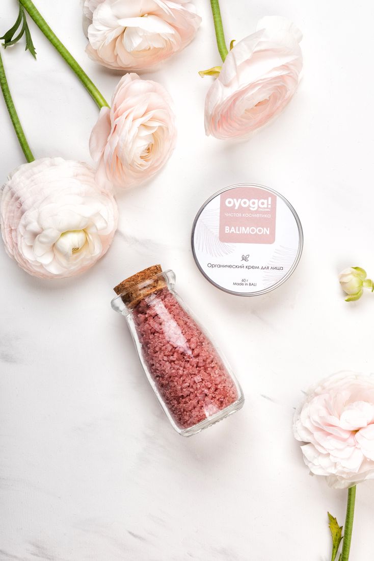 Organic balm jar and bath salts with ranunculus flowers, flat lay product photography