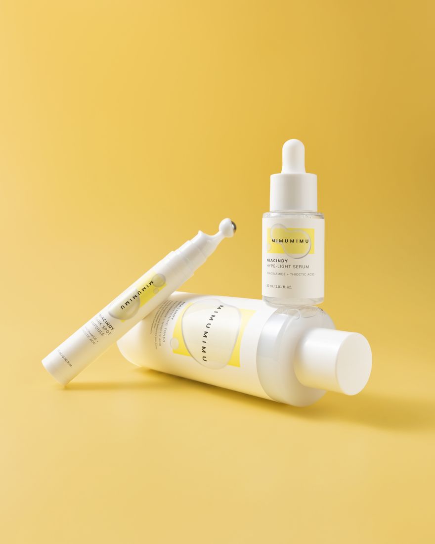 Skincare serum bottles on a yellow background, product photography Singapore