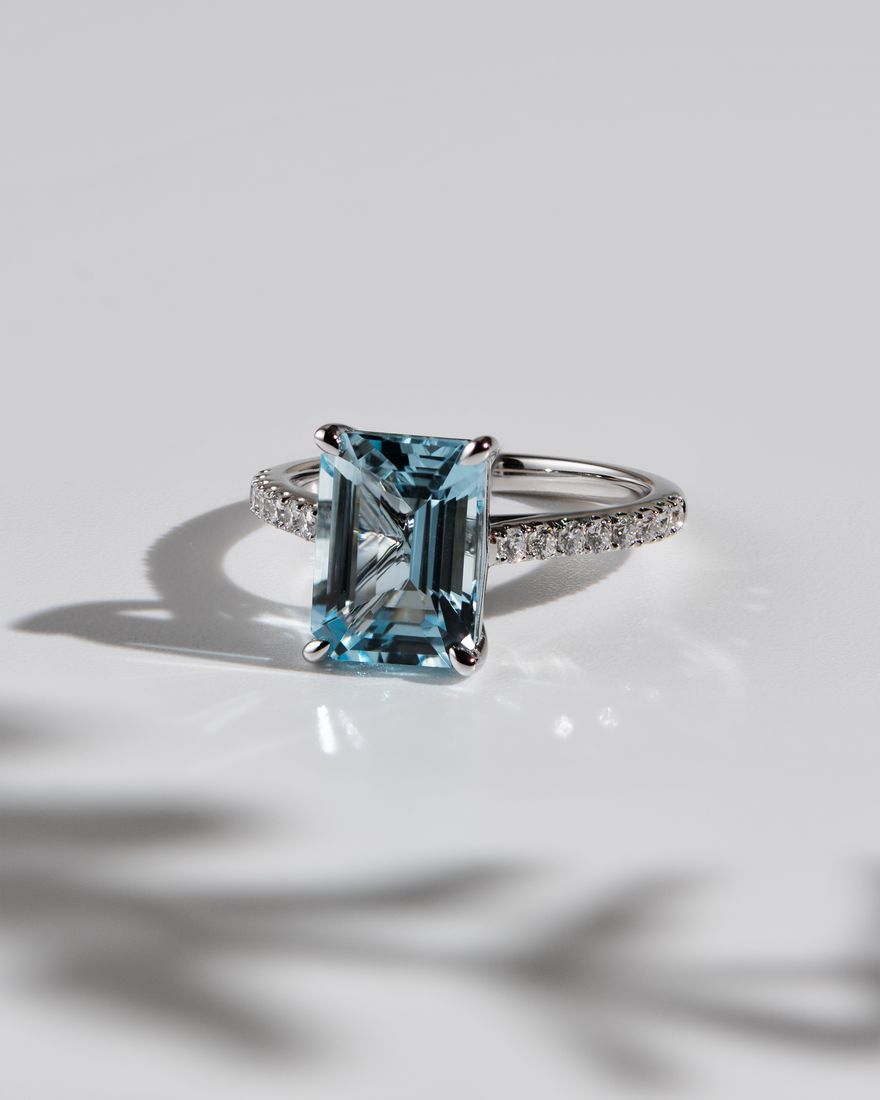 Aquamarine emerald-cut ring on light background, jewellery photography