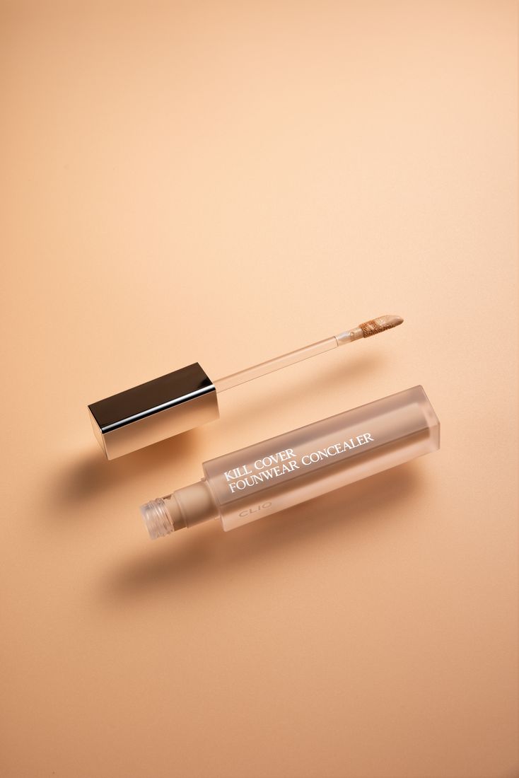 Concealer wand product photography on peach background