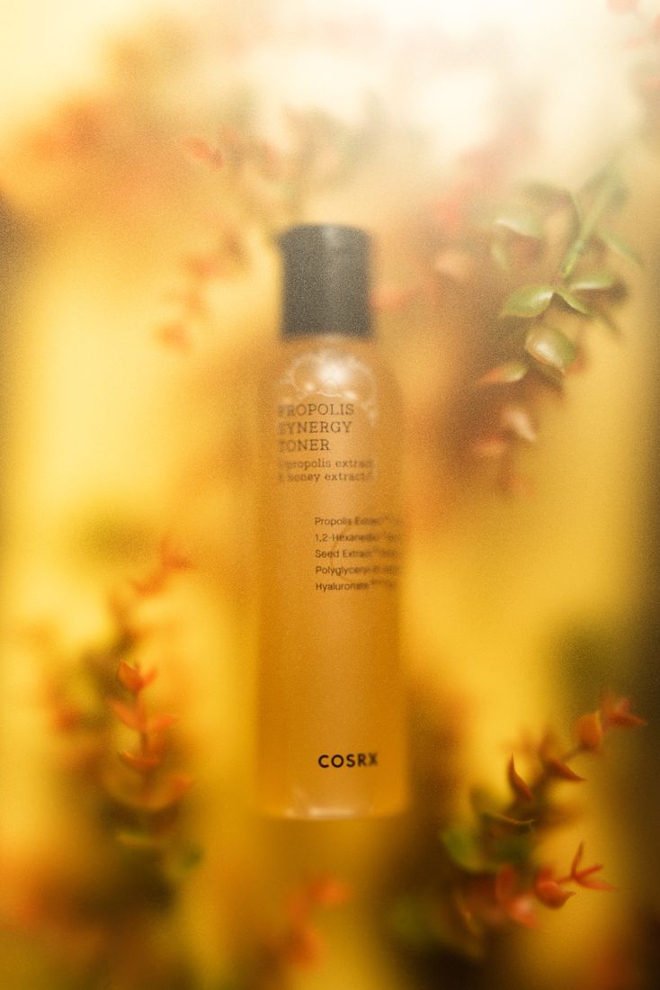 Skincare toner bottle with soft floral background, product photography Singapore