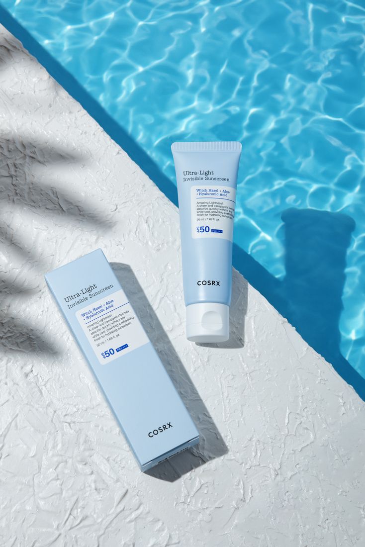 Sunscreen tube and box by a pool, skincare product photography Singapore
