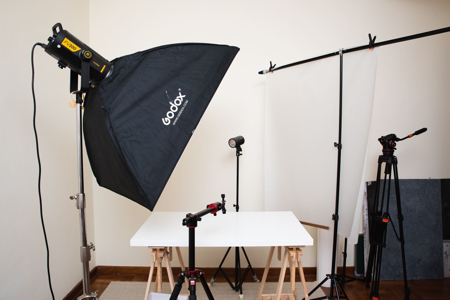 Dasha's home photo studio with a softbox light, a white shooting table and a seamless backdrop
