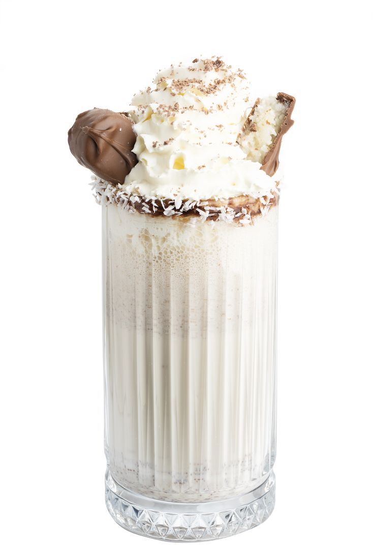 Coconut milkshake with whipped cream on white background, food photography