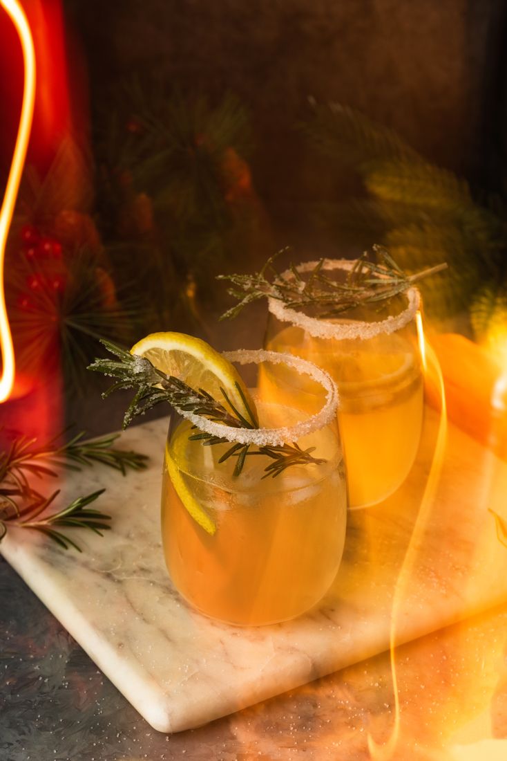 Rosemary citrus cocktails in warm festive light, drink photography